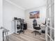 Well-lit home office with multiple workstations, light wood floors, and neutral paint color at 3252 Jasper Ln, Brownsburg, IN 46112