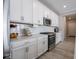 Well-lit kitchen boasts white cabinets, stainless steel appliances, and ample counter space for meal preparation at 3252 Jasper Ln, Brownsburg, IN 46112