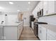 Spacious kitchen with white cabinets, stainless steel appliances, and a large center island at 3252 Jasper Ln, Brownsburg, IN 46112