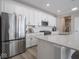 Modern kitchen features stainless steel appliances, white cabinets, and a spacious countertop, perfect for cooking and entertaining at 3252 Jasper Ln, Brownsburg, IN 46112