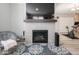Living room with modern fireplace, decorative rug, and comfortable seating, leading into a home gym at 3252 Jasper Ln, Brownsburg, IN 46112