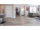 Open-concept living room featuring gray wood floors, recessed lighting, and contemporary artwork at 3252 Jasper Ln, Brownsburg, IN 46112