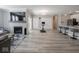 A bright, open-concept living space featuring sleek flooring, a fireplace, and access to the kitchen at 3252 Jasper Ln, Brownsburg, IN 46112