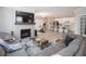 Open floor plan with living room, kitchen, and dining area, featuring modern fireplace and television at 3252 Jasper Ln, Brownsburg, IN 46112