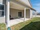 A covered patio area features a sliding door, white pillars, and a grill, perfect for outdoor entertaining at 3252 Jasper Ln, Brownsburg, IN 46112