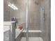 Beautiful walk-in shower features gray stone tile, a shower seat, and clear glass doors at 3252 Jasper Ln, Brownsburg, IN 46112
