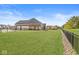 Expansive backyard featuring a well-manicured lawn, a covered patio, and a decorative fence at 3342 Challenger Dr, Plainfield, IN 46168