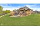 Spacious backyard view showing outdoor patio, kitchen and covered pergola with lush lawn at 3342 Challenger Dr, Plainfield, IN 46168