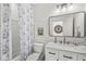 Clean bathroom featuring a floral shower curtain, white vanity, and ample lighting for a refreshing space at 3342 Challenger Dr, Plainfield, IN 46168
