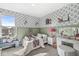 Bright bedroom with floral wallpaper, vanity, and seating area, creating a cozy and inviting space at 3342 Challenger Dr, Plainfield, IN 46168