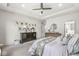 Bright bedroom with neutral decor, ceiling fan and a dresser showcasing an array of framed photos at 3342 Challenger Dr, Plainfield, IN 46168