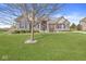 Stunning single-story house boasting stone and brick, a well-kept lawn, and a mature tree in the yard at 3342 Challenger Dr, Plainfield, IN 46168