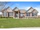 Beautiful house with a stone and brick exterior, well-maintained lawn, and a charming covered front porch at 3342 Challenger Dr, Plainfield, IN 46168