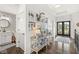 Stylish hallway featuring a powder room, decor on display, and views of the front door and backyard at 3342 Challenger Dr, Plainfield, IN 46168