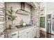 Close-up of kitchen with stone archway, stainless steel range hood, and white subway tile backsplash at 3342 Challenger Dr, Plainfield, IN 46168