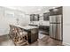 Basement kitchen with dark wood cabinets, stainless steel refrigerator, and modern countertops at 3342 Challenger Dr, Plainfield, IN 46168