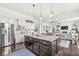 Modern kitchen featuring an island with granite countertops, stainless steel appliances, and open floor plan at 3342 Challenger Dr, Plainfield, IN 46168