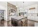 Kitchen with stone archway over gas range, white cabinets, stainless steel appliances, and a large center island at 3342 Challenger Dr, Plainfield, IN 46168