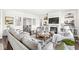 Bright living room with a fireplace, built-in shelves, and a view to the stairway; hardwood floors at 3342 Challenger Dr, Plainfield, IN 46168