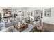 Cozy and bright living room featuring hardwood floors, a gray sectional couch, and an open layout at 3342 Challenger Dr, Plainfield, IN 46168