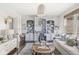 Comfortable living room featuring built-in shelves, a sofa, and a round wicker coffee table with decor at 3342 Challenger Dr, Plainfield, IN 46168