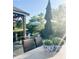 Inviting outdoor patio with wicker seating, an umbrella for shade, and lush landscaping at 3342 Challenger Dr, Plainfield, IN 46168