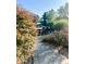 Charming outdoor patio area showcasing wicker furniture, a stone pathway, and beautiful landscaping at 3342 Challenger Dr, Plainfield, IN 46168