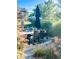 Outdoor patio featuring wicker chairs and table, complemented by umbrellas and beautiful landscaping at 3342 Challenger Dr, Plainfield, IN 46168