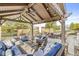 Covered pergola with outdoor seating, dining table, ceiling fan and string lights, perfect for entertaining at 3342 Challenger Dr, Plainfield, IN 46168