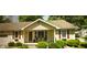 Charming single-story home features red shutters, a cozy porch, and well-maintained landscaping with green bushes at 338 N Darlington St, Jamestown, IN 46147