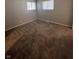 Cozy bedroom featuring neutral walls, plush carpeting, and abundant natural light from two windows at 3830 Aloda St, Indianapolis, IN 46203
