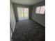 Bedroom featuring plush carpeting, a sliding door, and a window with a view of the outdoors at 3830 Aloda St, Indianapolis, IN 46203