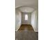 Welcoming hallway with neutral paint, wood floors, and storage closets at 3830 Aloda St, Indianapolis, IN 46203