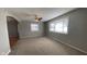 Inviting living room featuring neutral carpet, fresh paint, and plenty of natural light from bay windows at 3830 Aloda St, Indianapolis, IN 46203