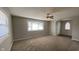 Inviting living room featuring neutral carpet, fresh paint, and plenty of natural light from bay windows at 3830 Aloda St, Indianapolis, IN 46203