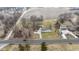An aerial view showcasing a home with a long driveway, separate garage, and expansive front lawn at 4251 W 176Th St, Sheridan, IN 46069