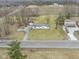 An aerial shot of a home with a long drive, set on a large lot surrounded by landscaping and adjacent fields at 4251 W 176Th St, Sheridan, IN 46069