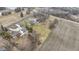 An aerial perspective showing two houses, large yards, and a nearby agricultural field, highlighting the spacious setting at 4251 W 176Th St, Sheridan, IN 46069