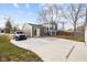 View of a gray house with a sliding glass door to the backyard and a detached garage with a car parked nearby at 4407 Barnor Dr, Indianapolis, IN 46226