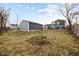 View of a house with a gray detached garage in the backyard and some yard area at 4407 Barnor Dr, Indianapolis, IN 46226