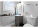 Bright bathroom features a window over the sink, neutral paint and toilet at 4407 Barnor Dr, Indianapolis, IN 46226