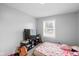 This bedroom features a window, carpeted floor and is equipped with a television and entertainment center at 4407 Barnor Dr, Indianapolis, IN 46226