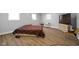 The bedroom has natural light from two windows, vinyl wood flooring, neutral colors and minimalistic furniture at 4407 Barnor Dr, Indianapolis, IN 46226