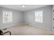 Bedroom featuring two windows, neutral carpet, and minimal decor at 4407 Barnor Dr, Indianapolis, IN 46226