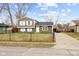 Charming home with a fenced front yard, features a long driveway and a well-maintained lawn at 4407 Barnor Dr, Indianapolis, IN 46226
