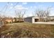 Gray detached garage at the back of a lot with an open bay door, some yard and other houses at 4407 Barnor Dr, Indianapolis, IN 46226