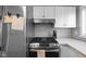 Updated kitchen with stainless steel appliances, modern countertops, and sleek backsplash at 4407 Barnor Dr, Indianapolis, IN 46226
