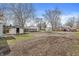 Expansive back yard with shed, storage, and partially-fenced perimeter at 524 S State St, Greenfield, IN 46140
