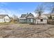 View of the home's backyard, featuring a fire pit and detached shed at 524 S State St, Greenfield, IN 46140