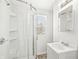 Bright bathroom featuring a glass shower, white vanity, and natural light from the window at 524 S State St, Greenfield, IN 46140